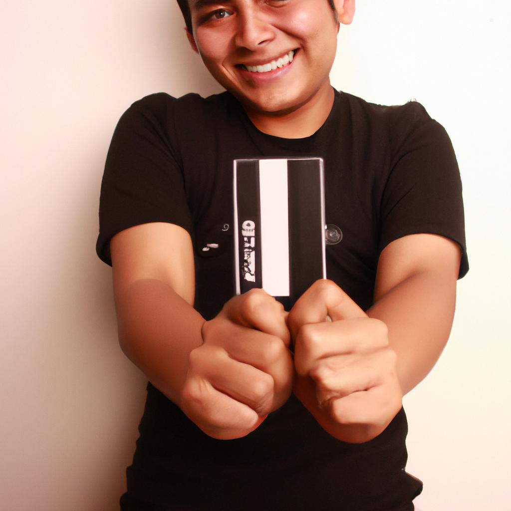 Person holding credit card, smiling